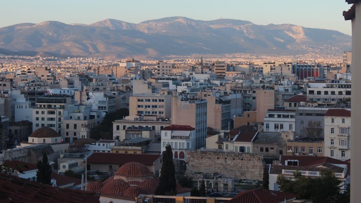 a view of a city with mountains in the background